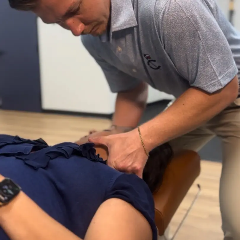 Dr. Seth Little performing a gentle neck adjustment on a patient at Limitless Chiropractic in Alliance Town Center, Fort Worth, TX, to relieve pain and improve mobility.