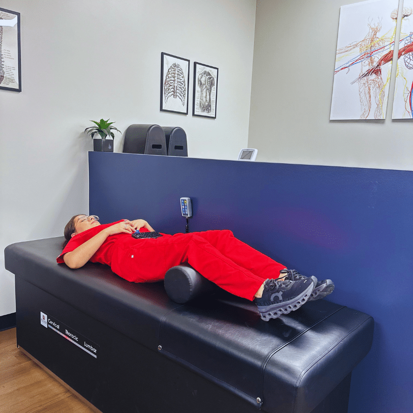 Patient receiving Intersegmental Traction (IST) therapy in Alliance Town Center at Limitless Chiropractic for lower back pain relief.