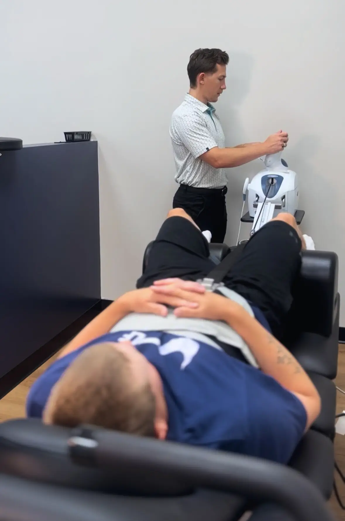 Dr. Seth Little performing spinal decompression therapy for lower back pain at Limitless Chiropractic in Alliance Town Center