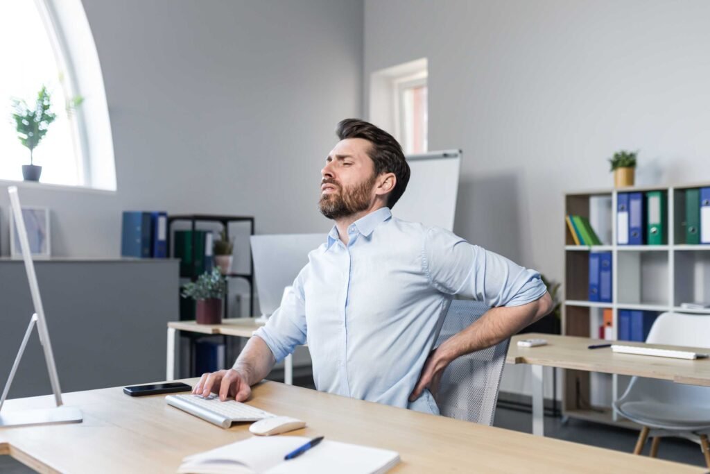 Businessman at work tired has severe back pain 8l48x9t 1024x683